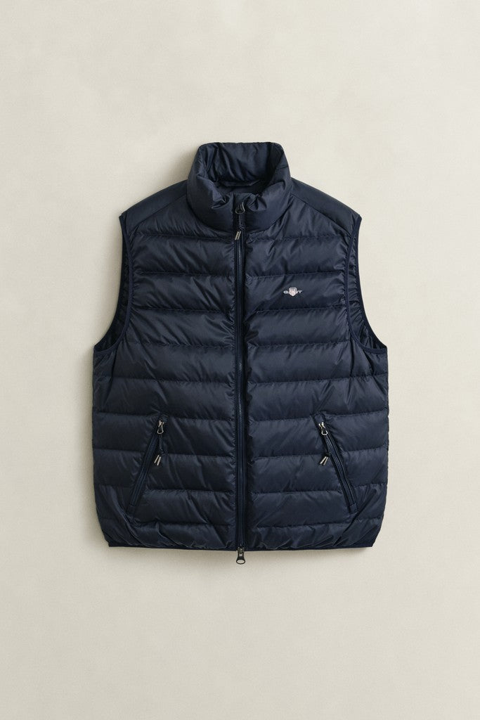 Navy blue GANT puffer Gilet with small GANT logo on the left chest and zipped side pockets. Flat against a light grey surface.