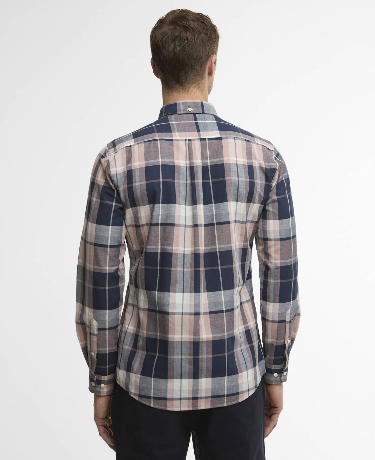 Man wearing a plaid shirt with a white background