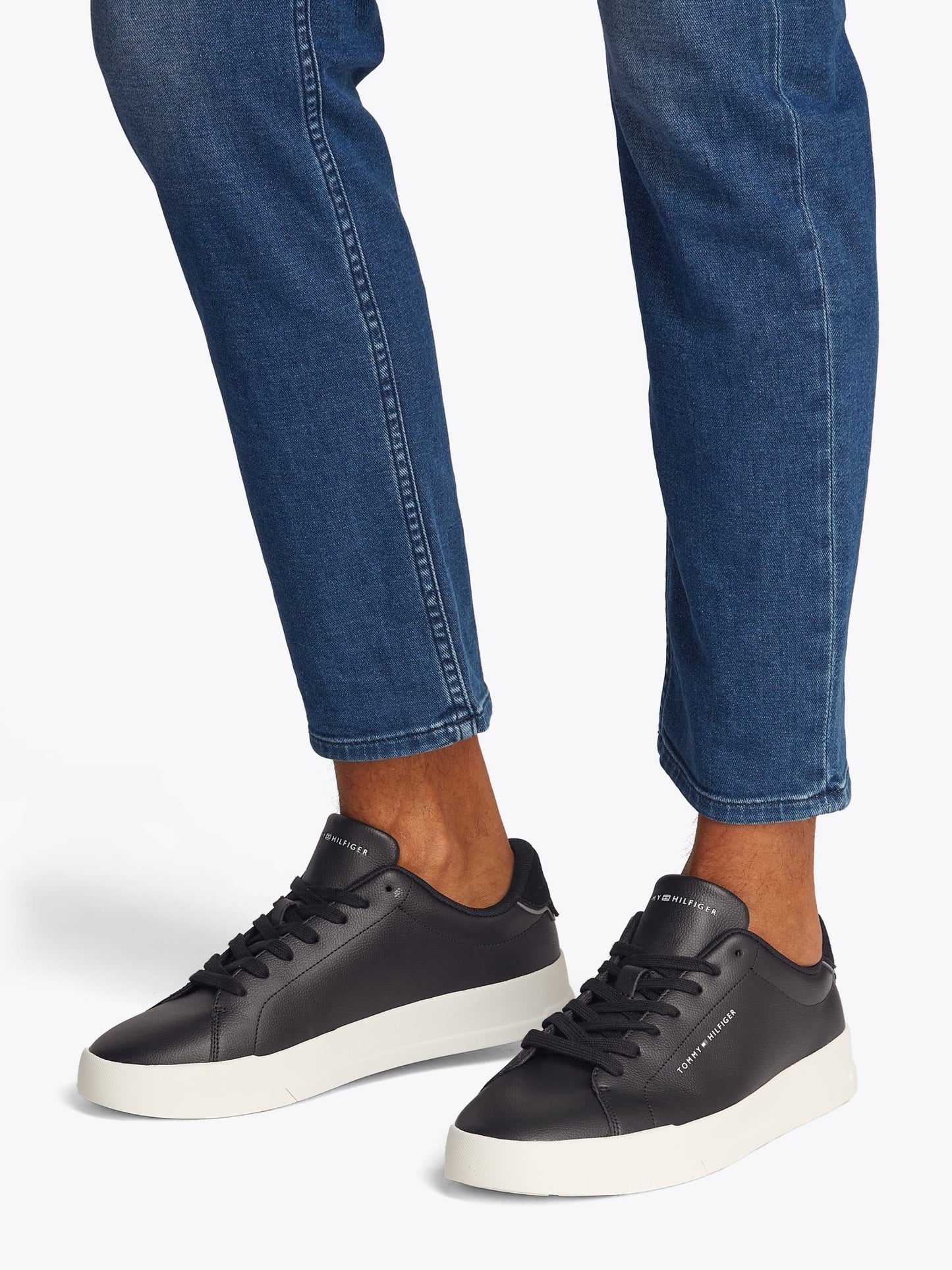Tommy Hilfiger Essential Leather Court Shoes on model, side view, black - Matt O'Brien Fashions