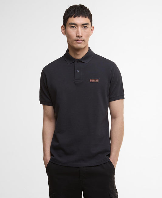 Barbour International Essential Polo Shirt. Man wearing a dark navy polo shirt with a Barbour logo on a white background - Matt O'Brien Fashions
