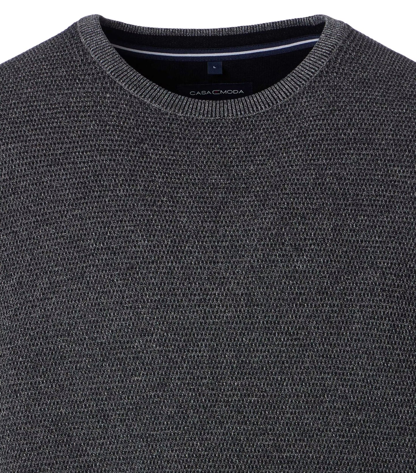 Close-up of a dark gray sweater with 'CasaModa' branding.