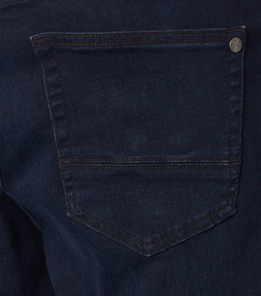 Close up of back pocket of dark blue jeans with tonal stitching and a small brand logo