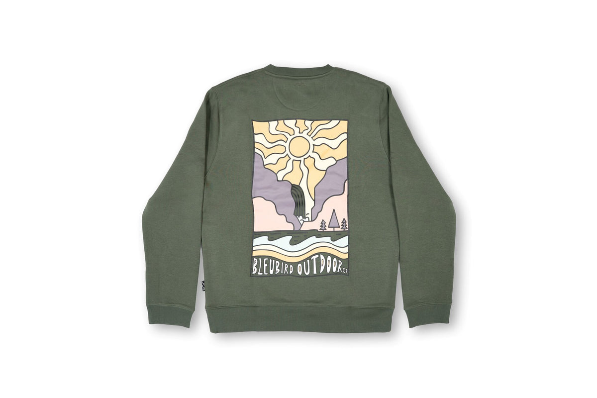 An olive green crewneck sweatshirt shown from the back, featuring a large square graphic print with a stylized sun, mountains, and the text 'BLEUBIRD OUTDOOR Co.' on a plain white background.