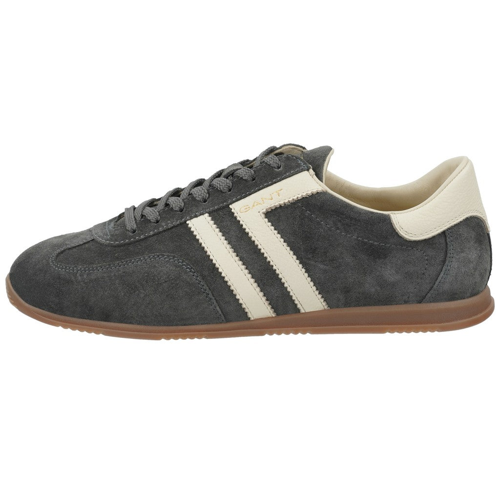 A dark gray suede sneaker with two cream stripes, a cream heel tab, and a brown gum sole, shown in a side profile on a white background.