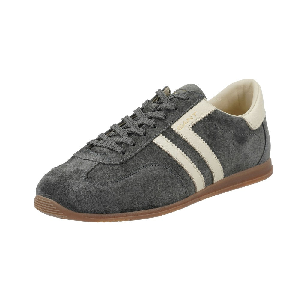 A dark gray suede sneaker with two cream stripes, a brown gum sole, and gray laces, shown from a three-quarters angle on a white background.