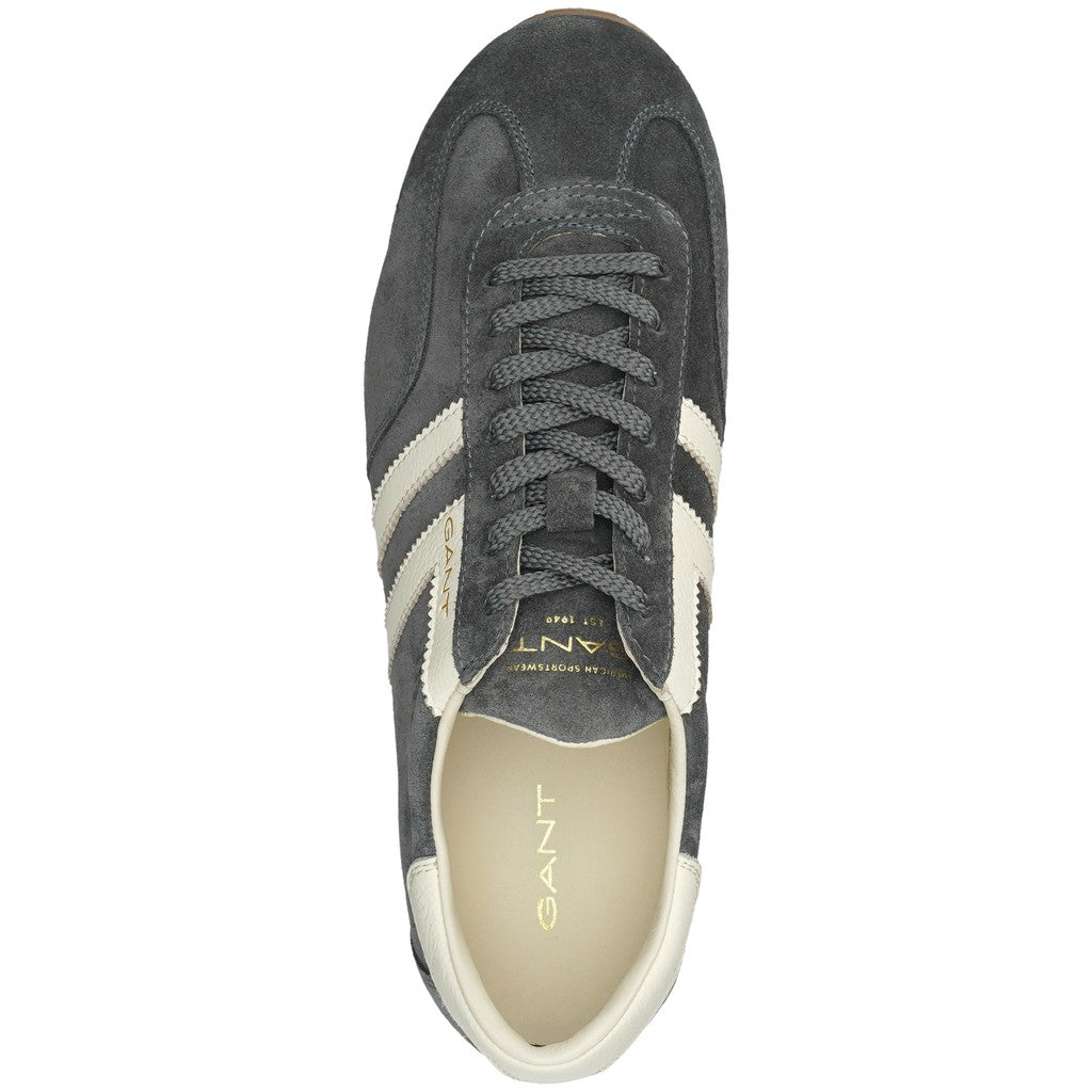 A single dark gray suede sneaker shown from a top-down view on a white background. The shoe features two cream stripes on the side, a cream lining, and gold branding details.