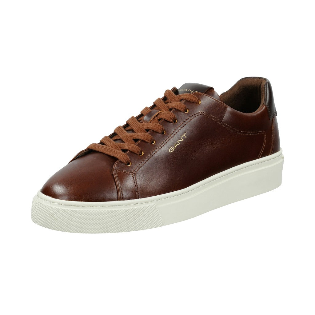 A GANT brown leather low-top sneaker with matching brown laces and a thick white platform sole, shown from a three-quarters angle on a white background.