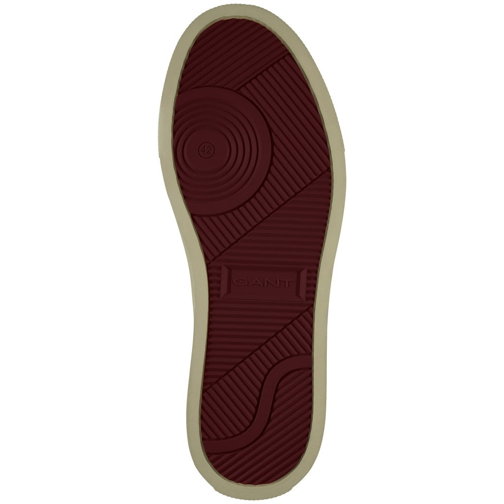 The outsole of a shoe shown from a top-down view, featuring a deep burgundy textured tread with the brand name 'GANT' embossed in the center, bordered by a light beige edge on a white background.