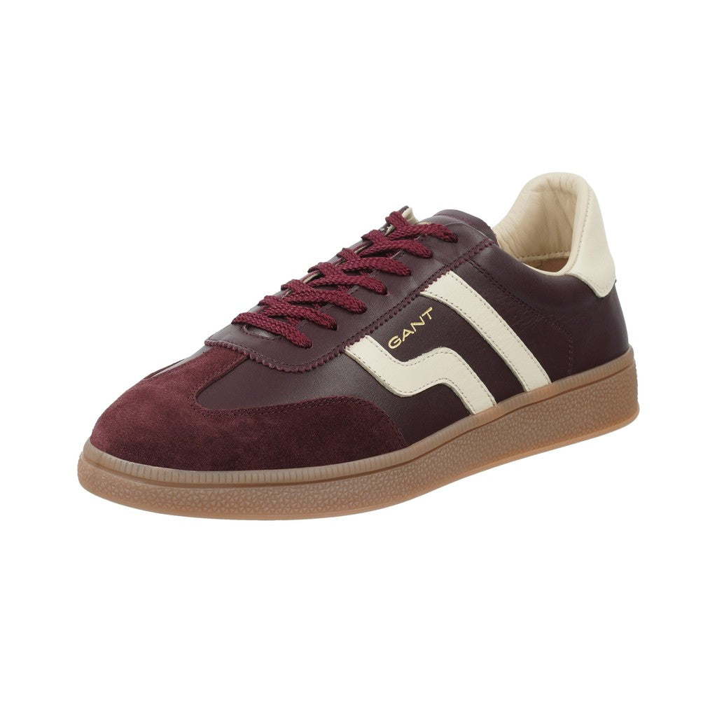 A GANT low-top sneaker in burgundy and cream leather with a tan gum sole, shown from a three-quarters angle on a white background.