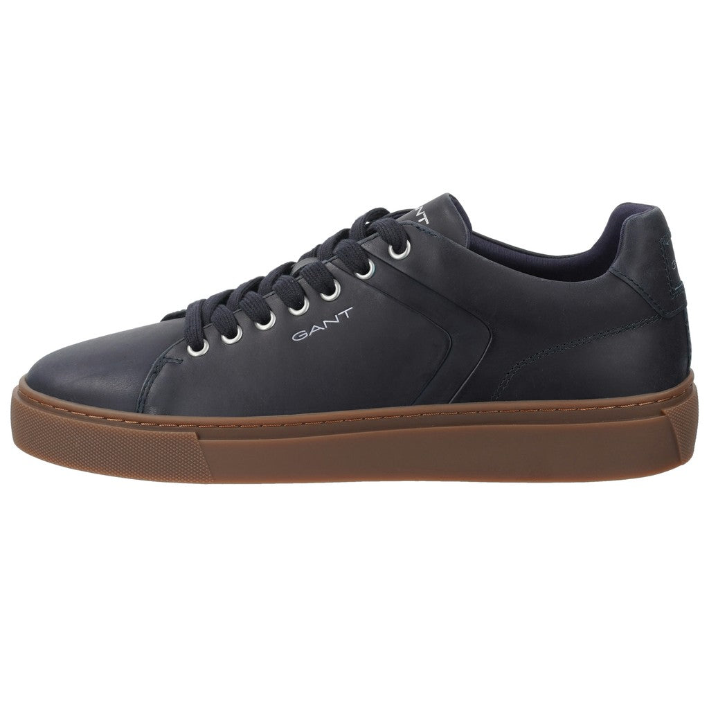 A GANT low-top sneaker in dark navy blue leather with a brown gum sole, shown from a side profile view on a white background.