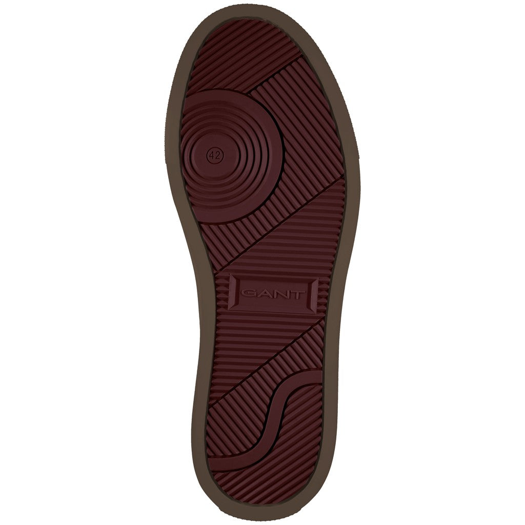 The outsole of a GANT shoe, showing a dark reddish-brown tread pattern with the GANT brand name embossed in the center, isolated on a white background.