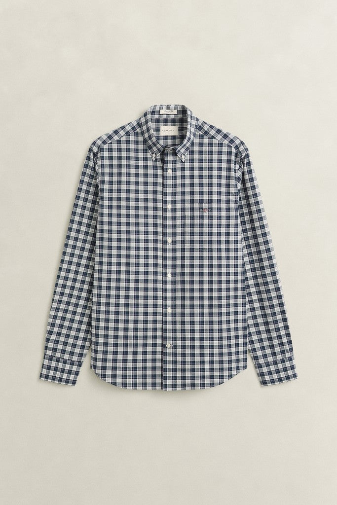 A long-sleeve button-down shirt in a navy and white gingham check pattern, displayed flat against a light beige background.