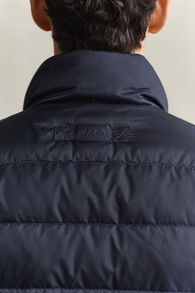 Man wearing a GANT puffer jacket with visible locket loop and GANT logo shown from behind