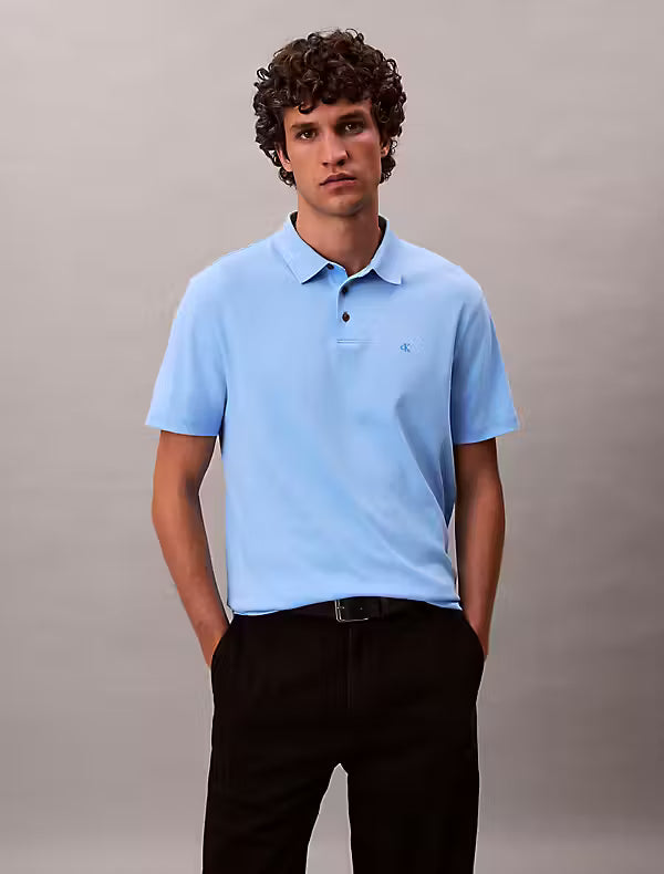 Calvin Klein Supima Cotton Polo. Man wearing a blue polo with CK logo on the chest and black trousers - Matt O'Brien Fashions