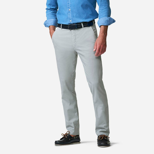 Person wearing light gray pants with a blue shirt on a white background