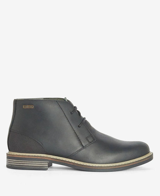 A Black leather lace-up ankle boot with a stacked block heel and a beige welt stripe, shown from a side profile on a light gray background.