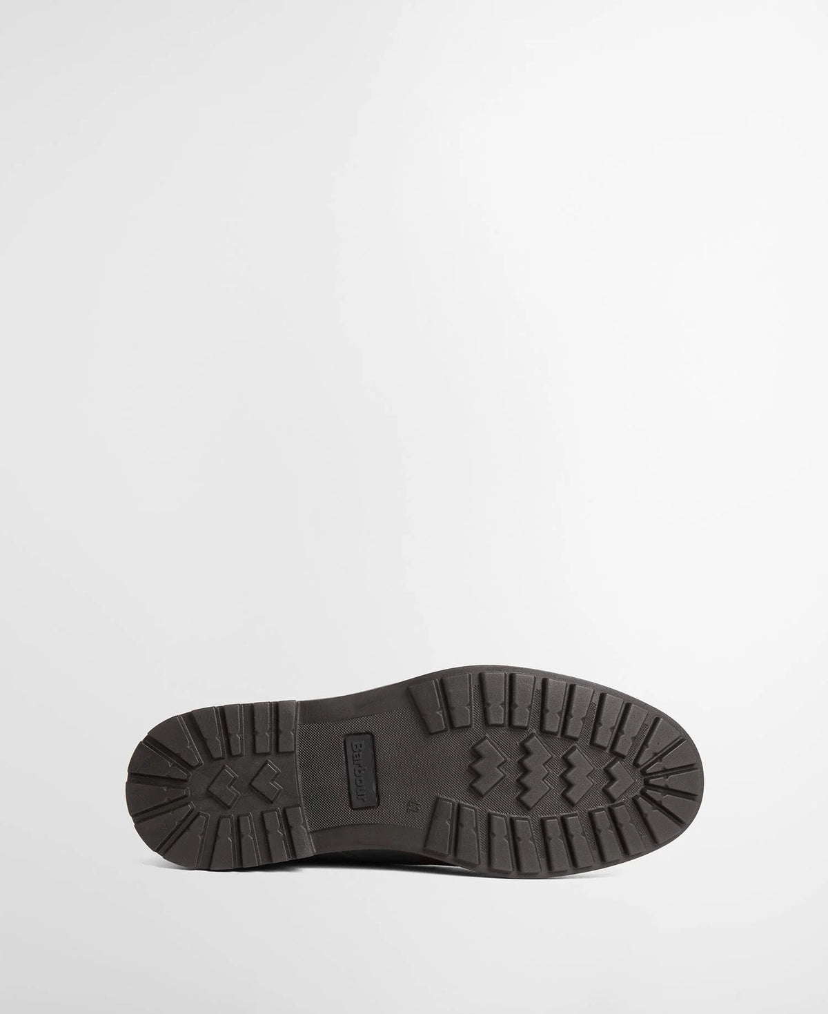 The bottom sole of a boot, showing a textured tread pattern and a small rectangular Barbour brand tab, photographed against a clean white background.