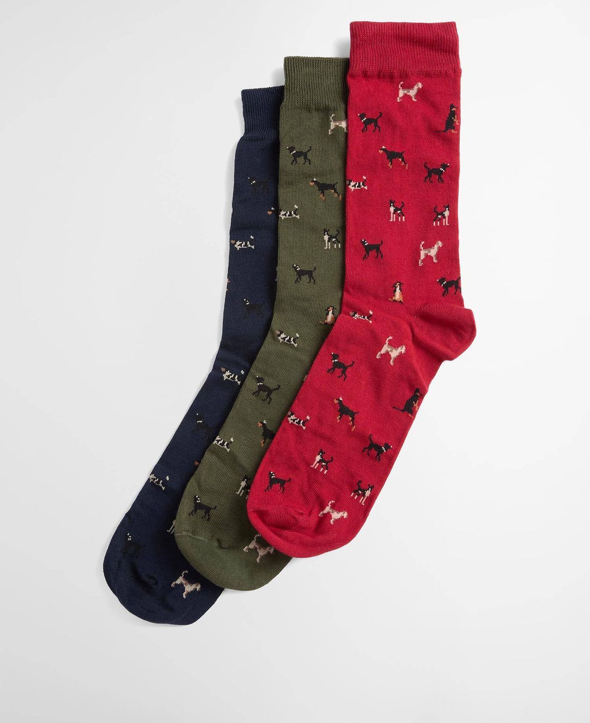 Three pairs of patterned crew socks in navy blue, olive green, and red, each featuring a small dog print, arranged diagonally on a light gray background.