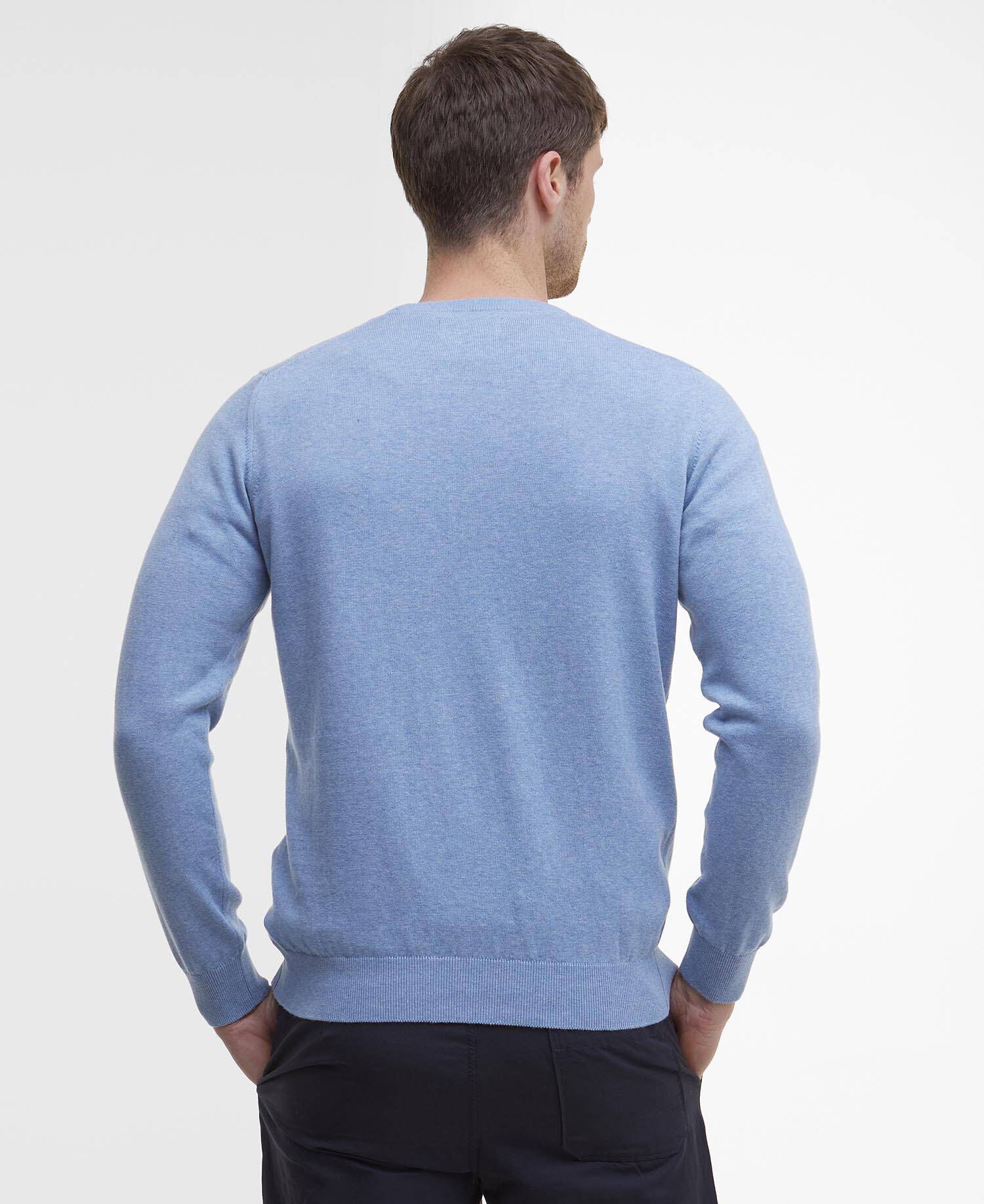 Man wearing a light blue sweater on a white background