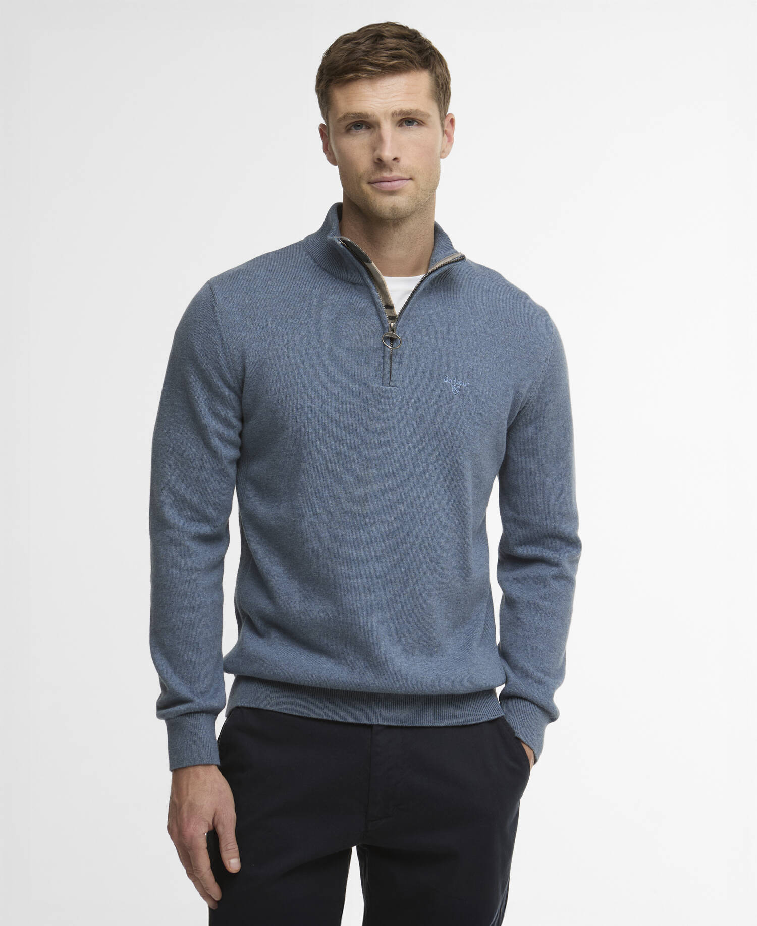 Man wearing a blue quarter-zip sweater on a white background