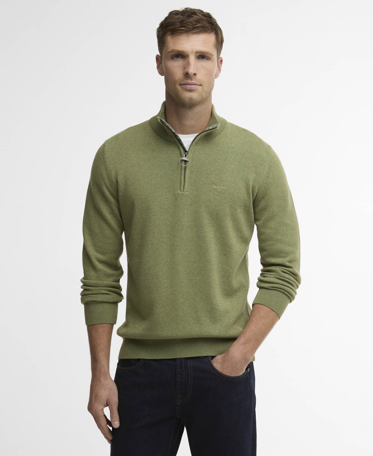 Man wearing a green zipped sweater with a white background