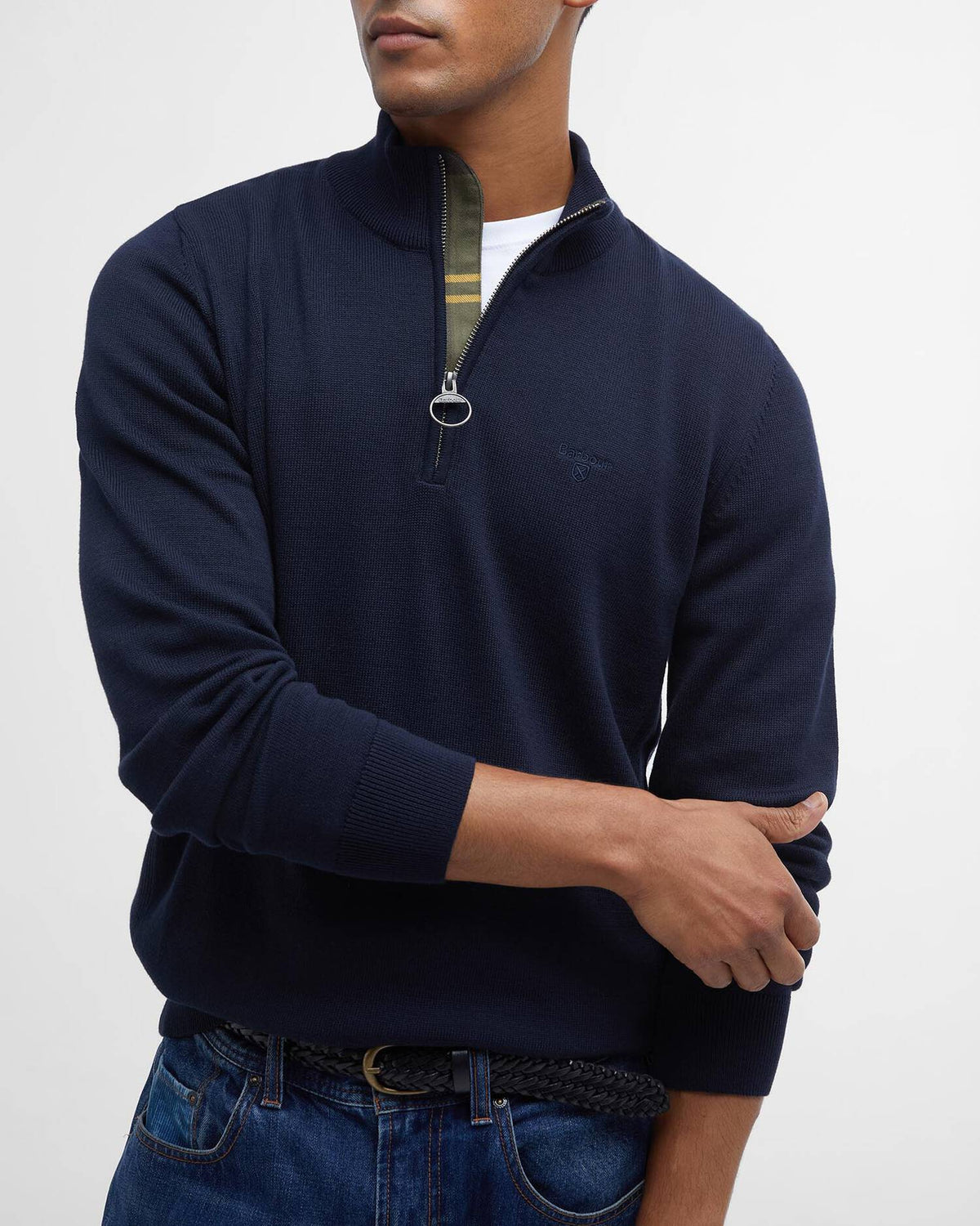 Man wearing a navy blue quarter-zip sweater with a white background