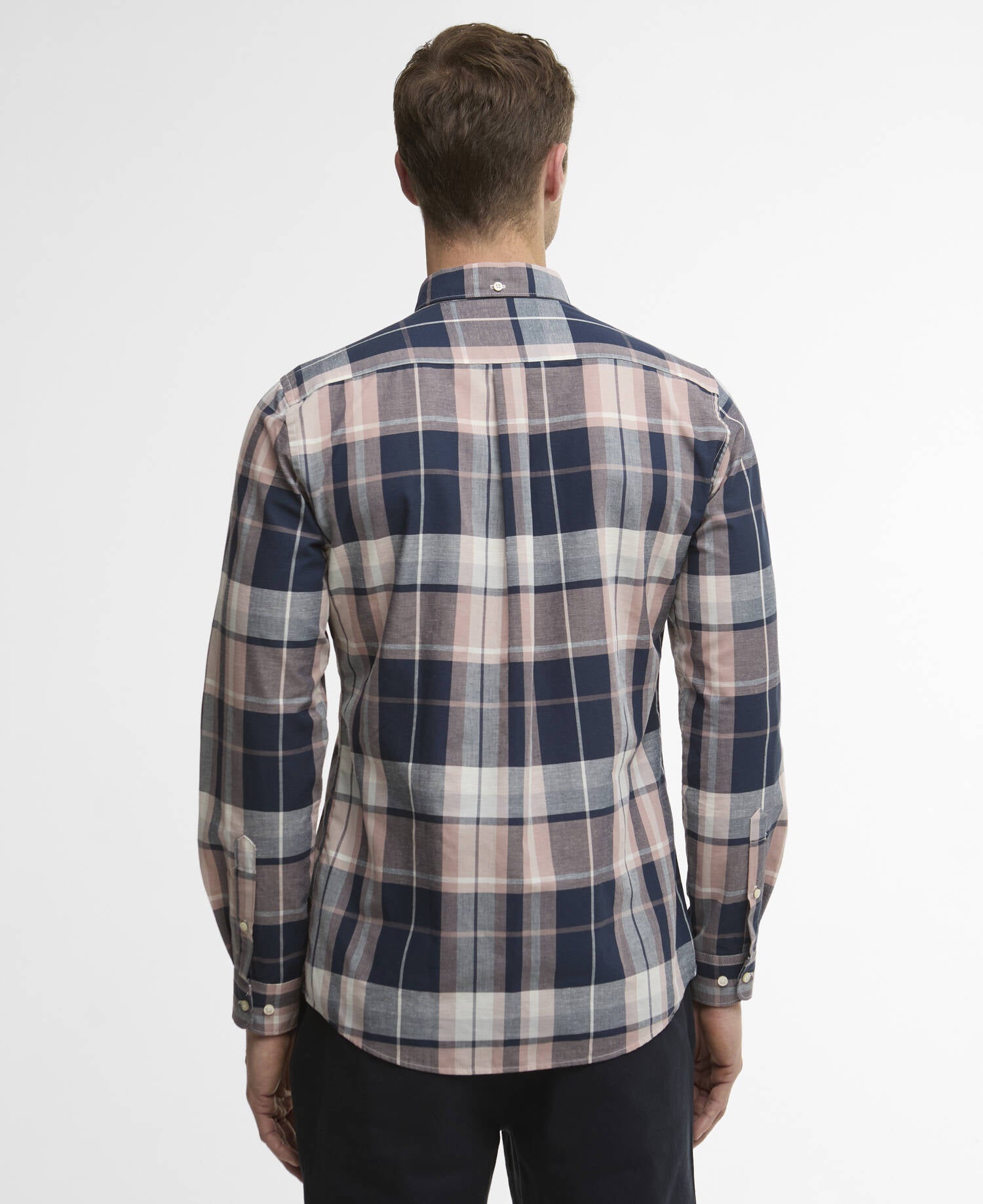 Man wearing a plaid shirt with a white background