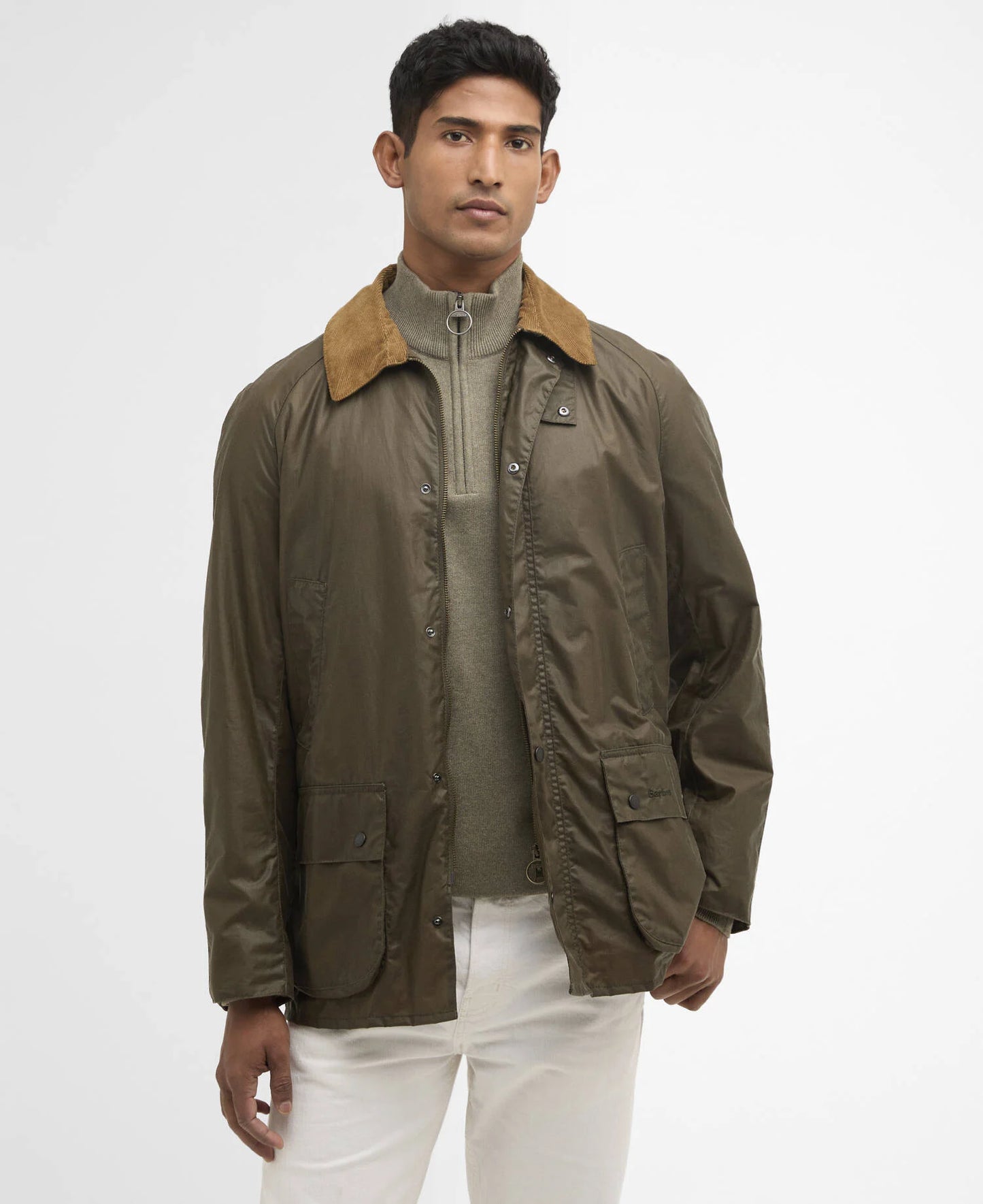Man wearing an olive jacket with a brown collar on a white background