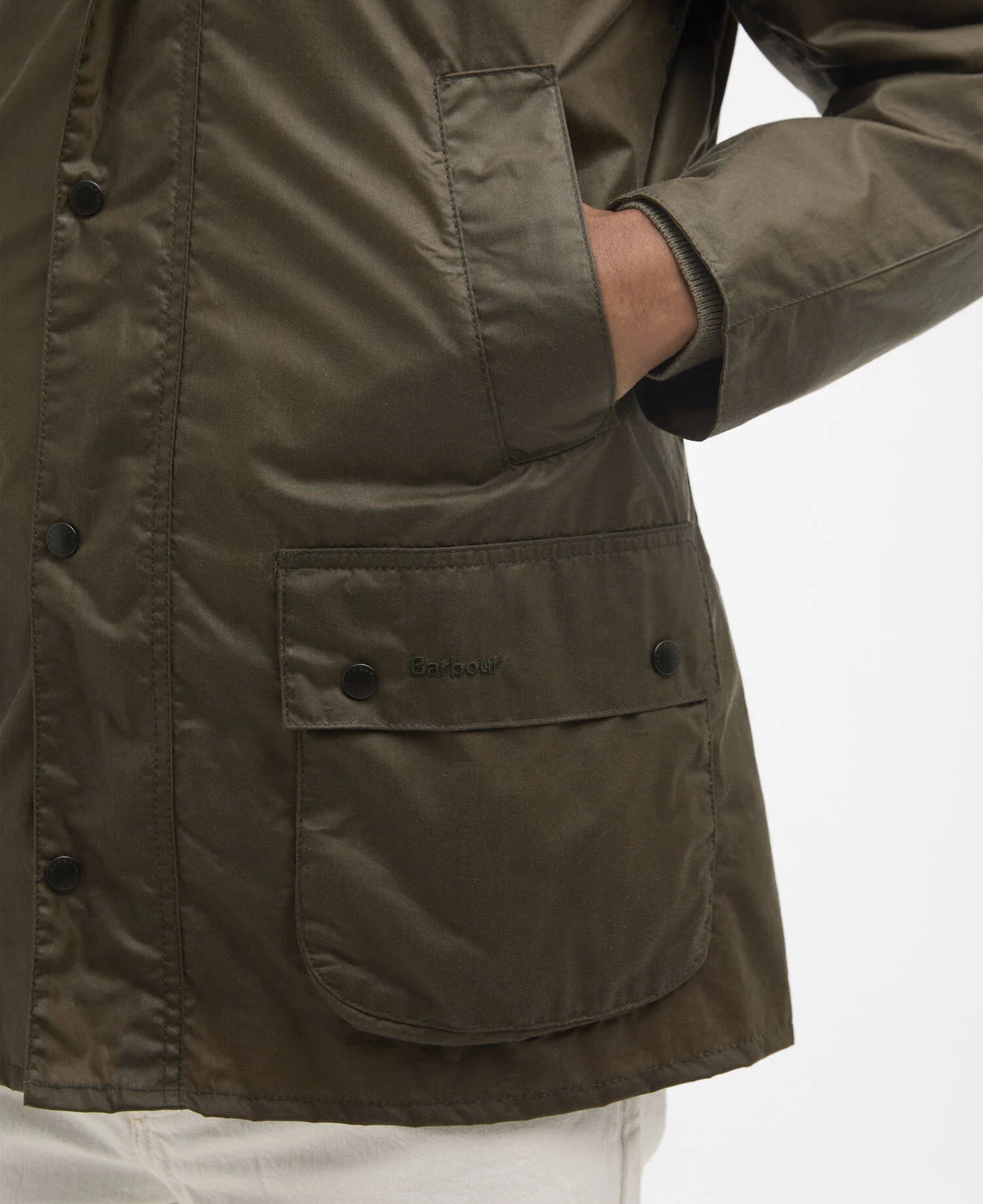 Olive green jacket with a visible Barbour brand logo on a white background