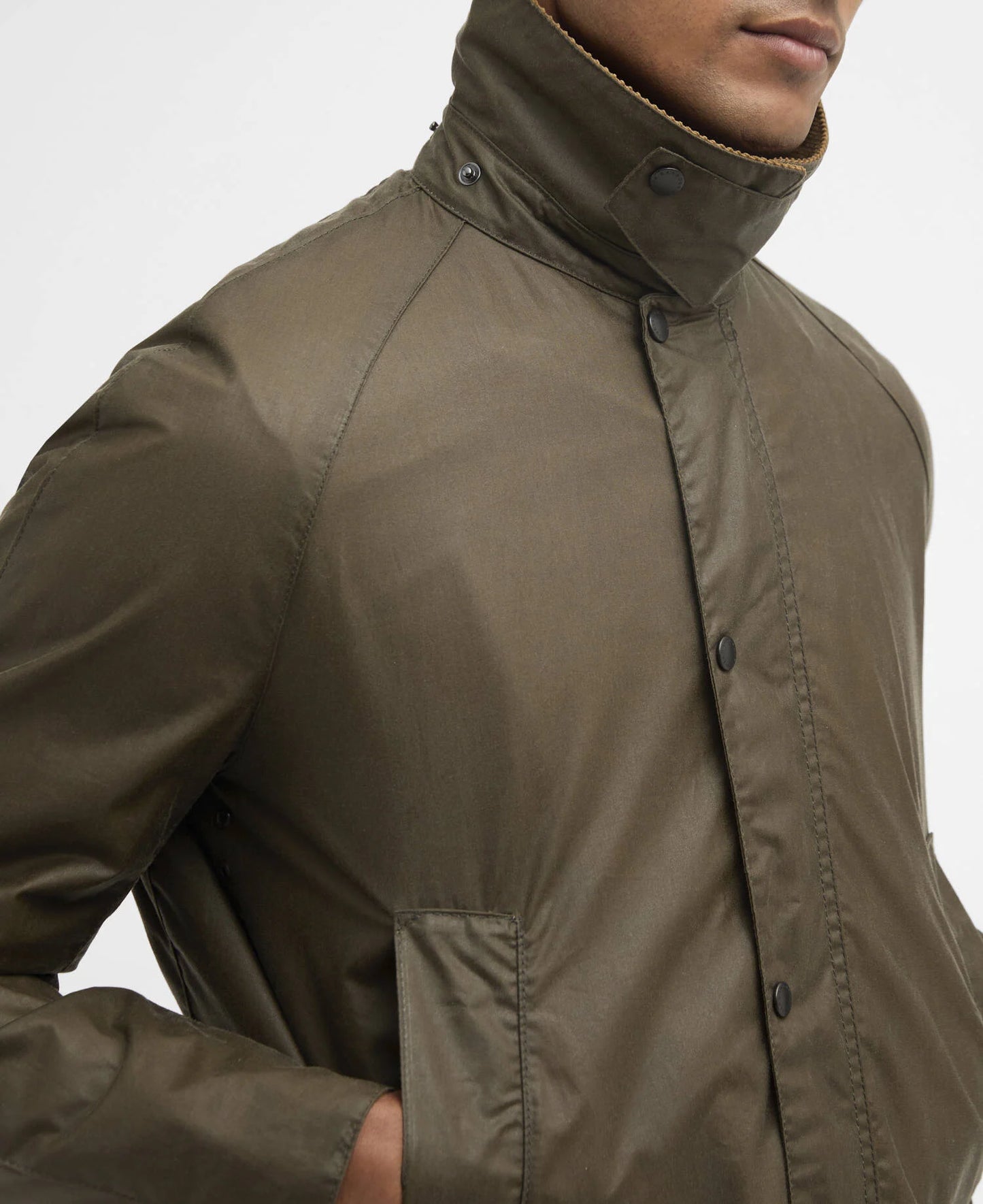 Close-up of a man wearing a green jacket on a white background