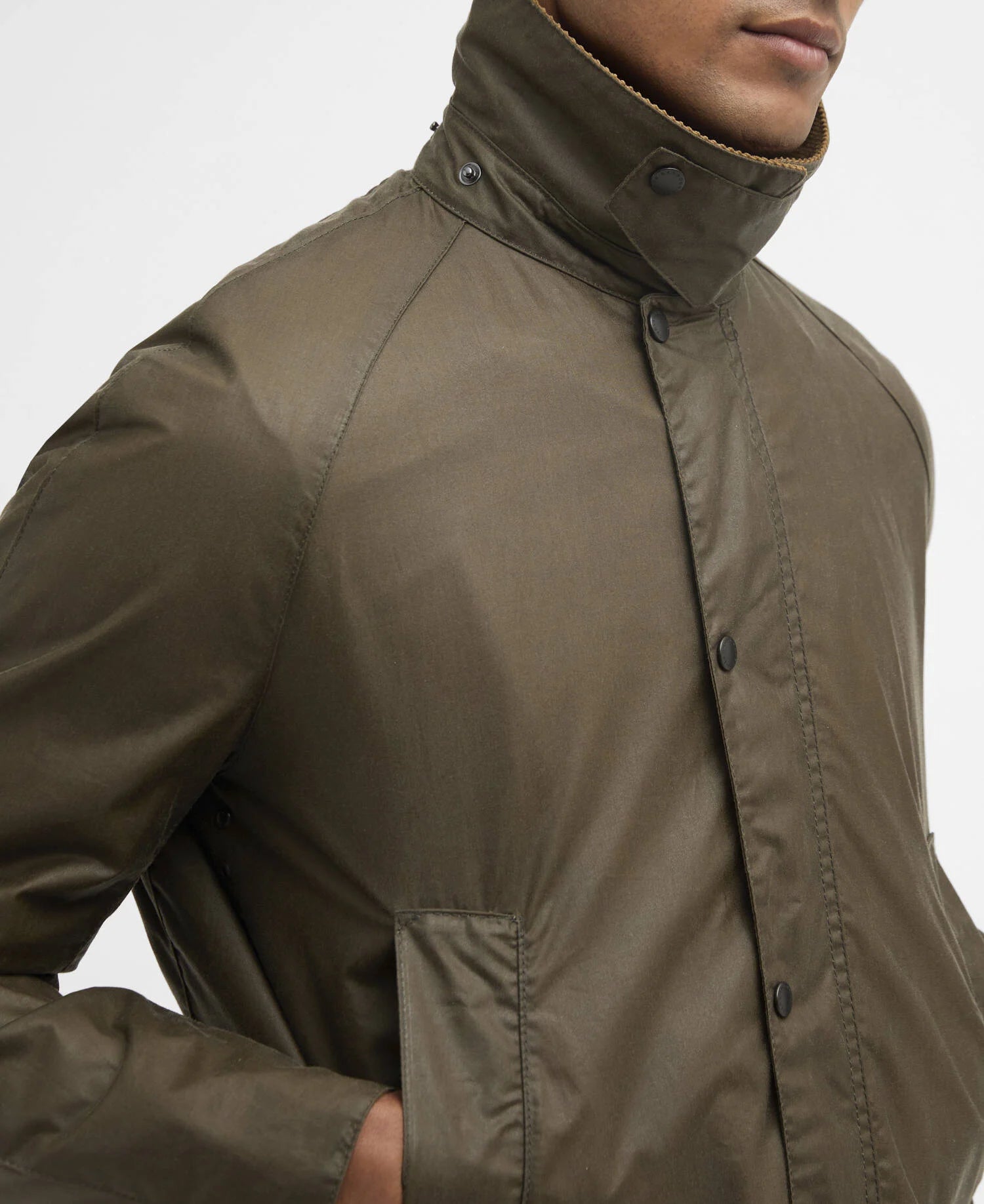 Close-up of a man wearing a green jacket on a white background