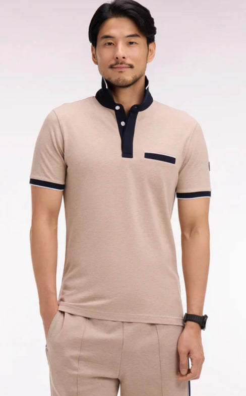 Man wearing a beige polo shirt with navy accents on a white background