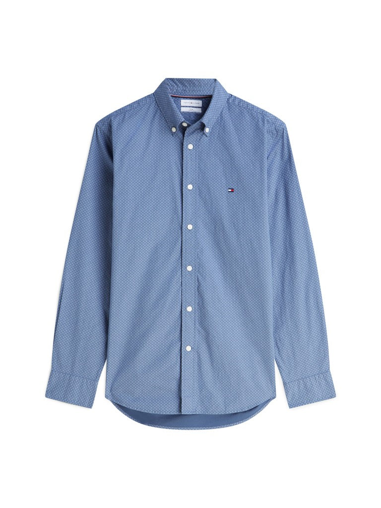 A light blue long-sleeve button-down shirt with a small embroidered Tommy Hilfiger flag logo on the left chest, displayed on a clean white background.
