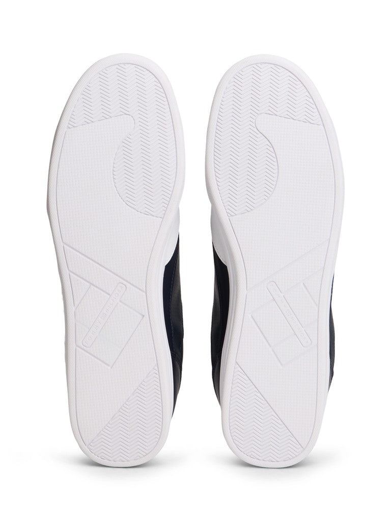 The outsoles of a pair of low-top sneakers, shown from the bottom view against a plain white background.