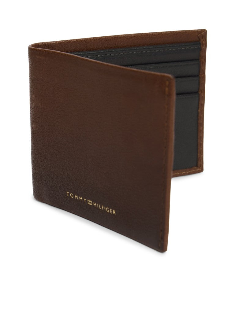 Brown leather wallet with 'Tommy Hilfiger' branding on a white background