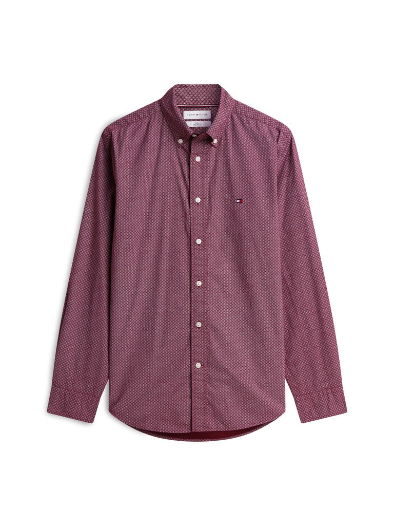 A long-sleeve button-down shirt in a dusty rose or mauve micro-pattern, featuring a small embroidered Tommy Hilfiger flag logo on the left chest, displayed on a clean white background.