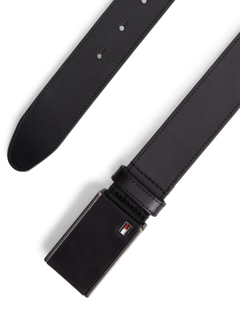 Buckle and tip of a black leather Tommy Hilfiger belt
