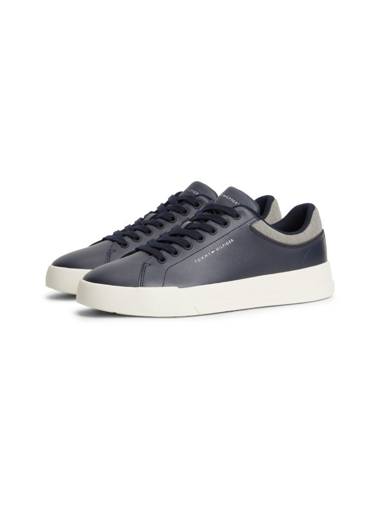 Pair of navy leather shoes with Tommy Hilfiger logo printed on the side on a white background