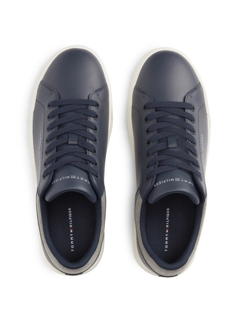 A pair of navy blue leather low-top sneakers by Tommy Hilfiger, shown from a top-down view on a clean white background.