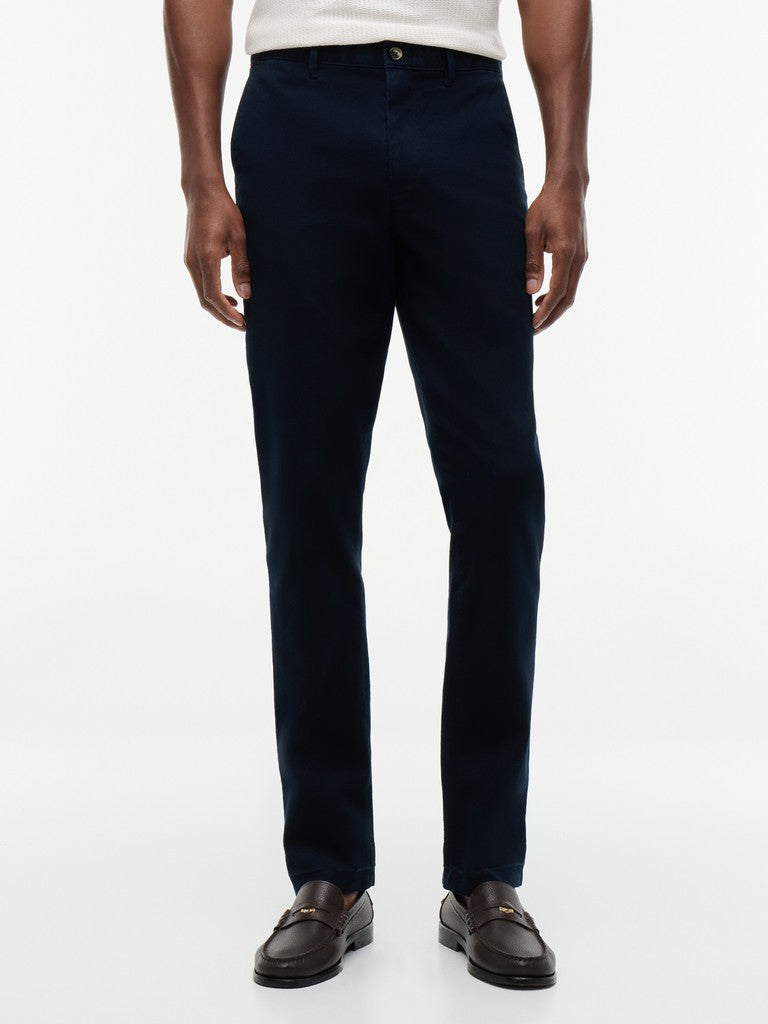 Person wearing dark blue pants on a white background