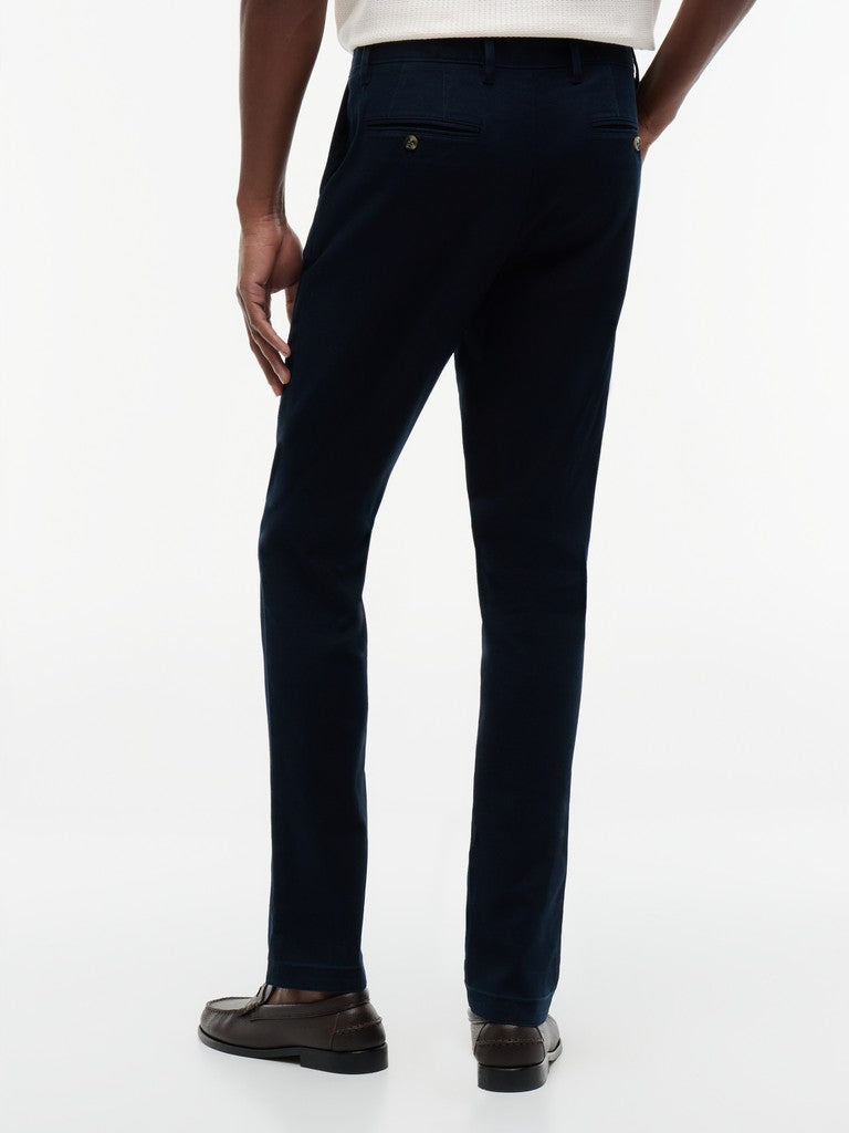 Navy pants worn by a person on a white background