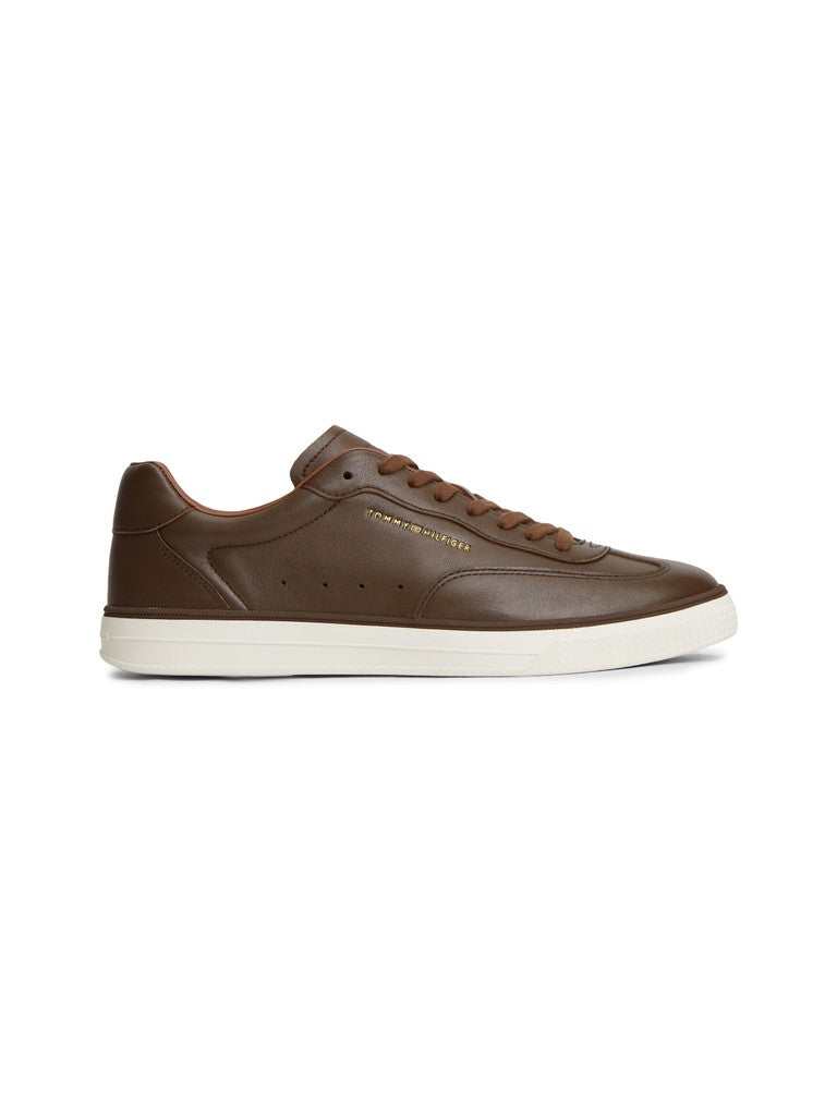 Brown sneaker with matching brown laces and white sole on a white background