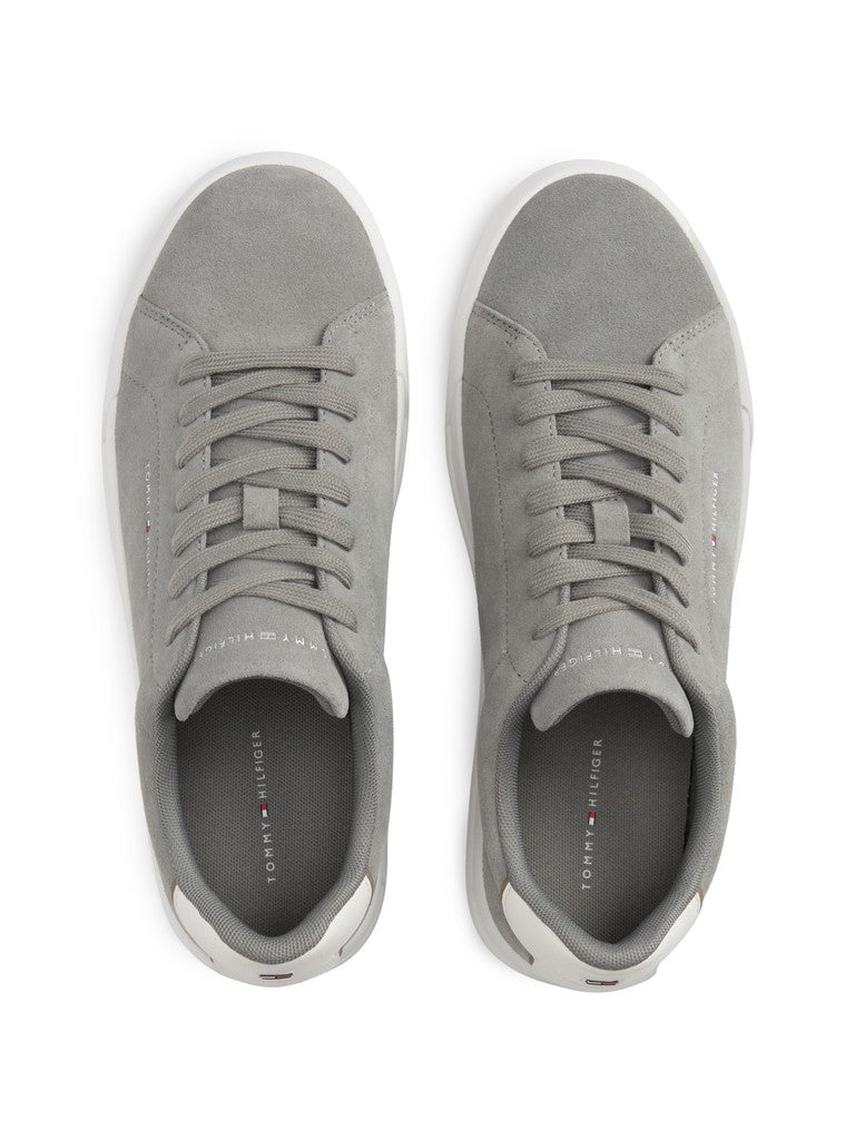 Pair of grey suede Tommy Hilfiger sneakers from the top with Tommy Hilfiger logo printed on the inside and on the outside