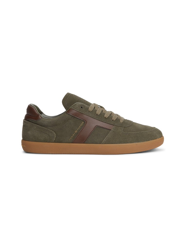 Green suede sneaker with brown detail and a Tommy Hilfiger logo in gold on the side on a white background
