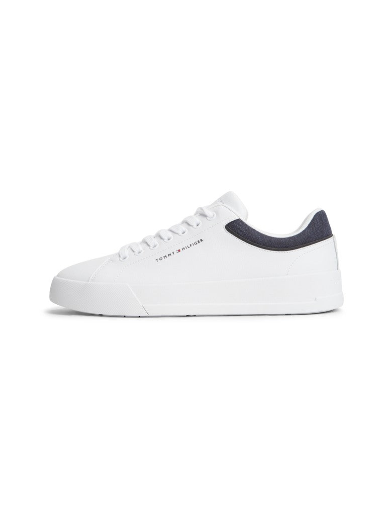A white low-top sneaker with a dark navy heel tab and white laces, shown from a side profile on a clean white background.