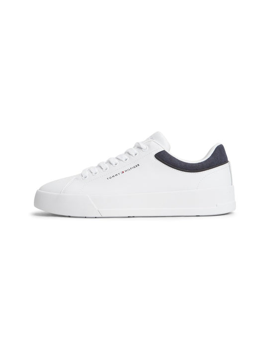 A white low-top sneaker with a dark navy heel tab and white laces, shown from a side profile on a clean white background.