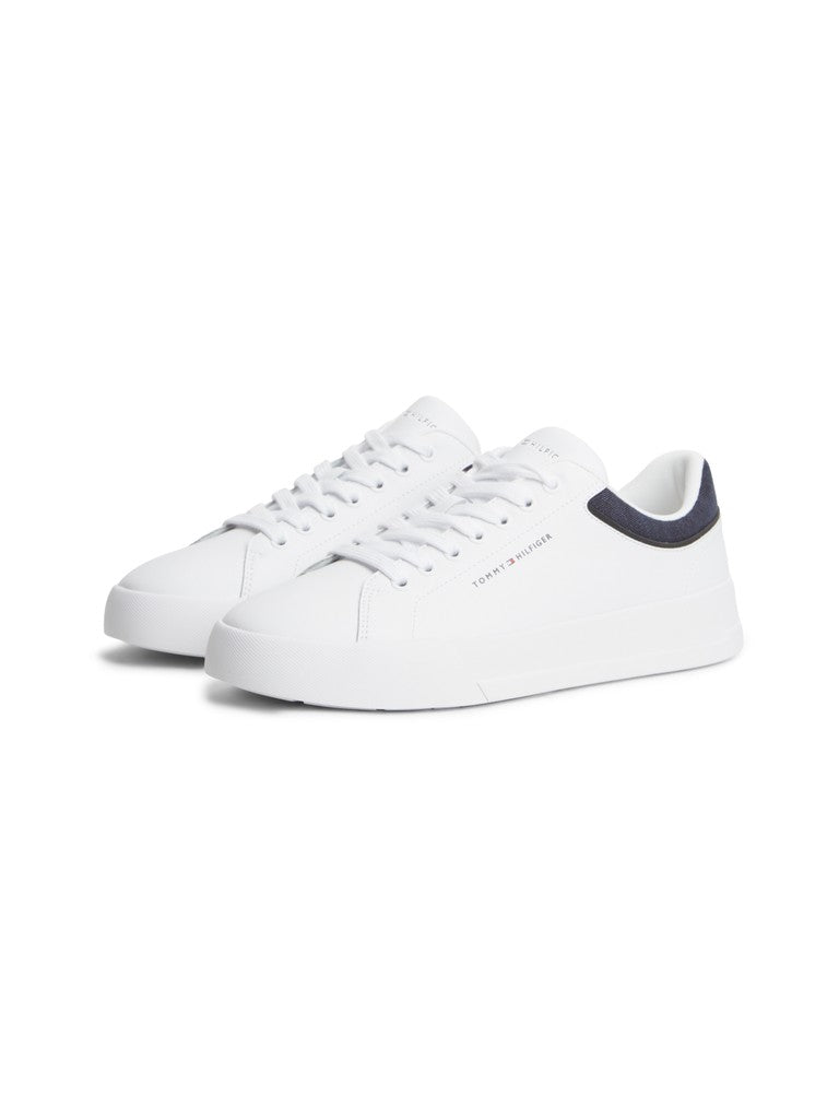 Pair of Tommy Hilfiger low top court sneakers with branding printed on the side and navy textile detail on the heel