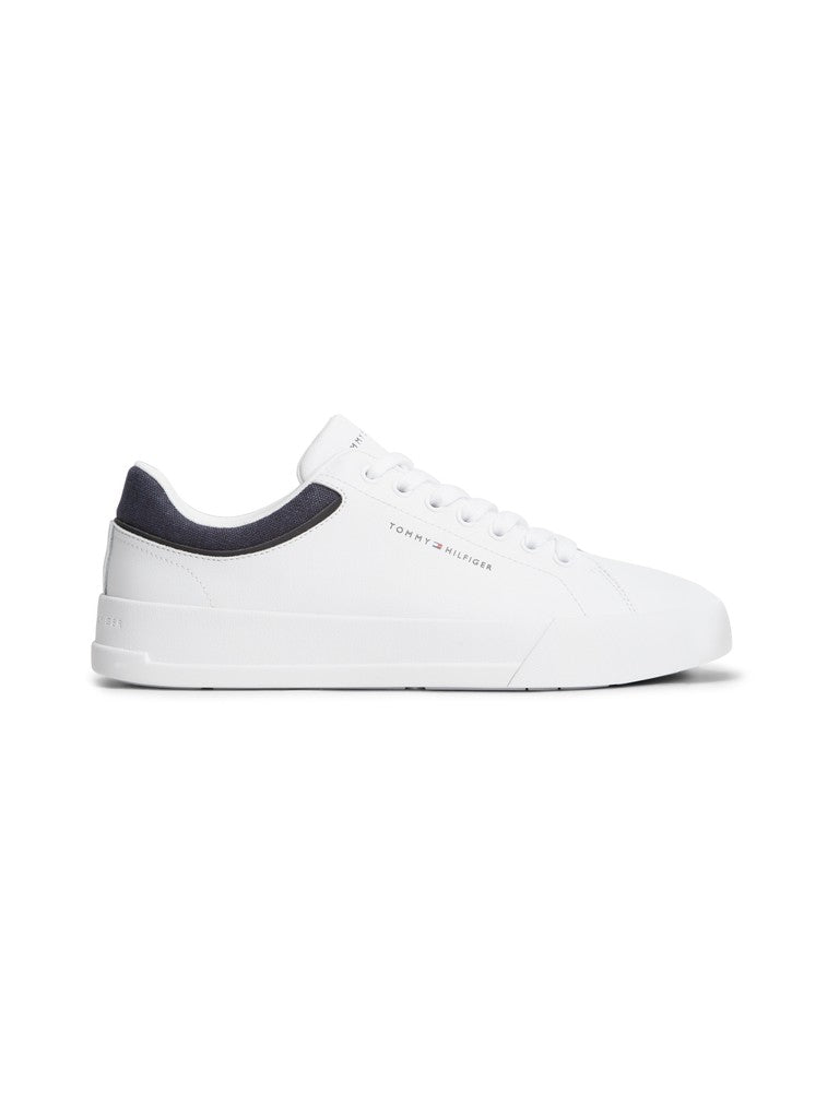 White low top sneaker with Tommy Hilfiger logo printed on the side featuring a textile heel detail in navy on a white background