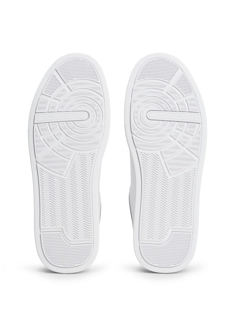 A pair of white low-top sneakers shown from the sole view, displaying detailed tread patterns against a clean white background.