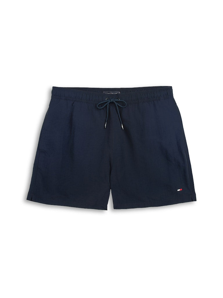 Navy blue drawstring shorts with a small Tommy Hilfiger flag logo on the lower left hem, displayed flat against a white background.